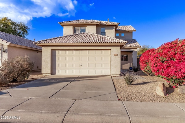 mediterranean / spanish-style home with a garage