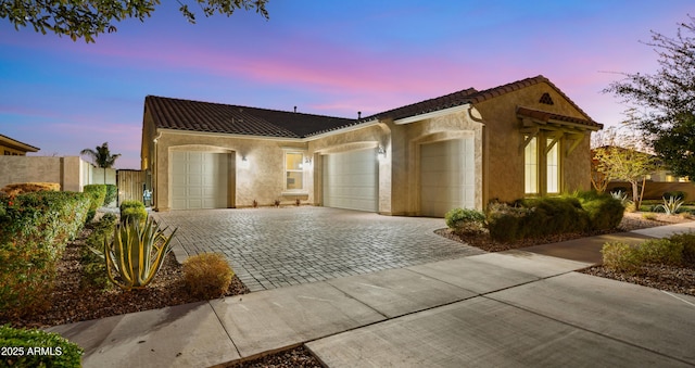 mediterranean / spanish-style home featuring a garage