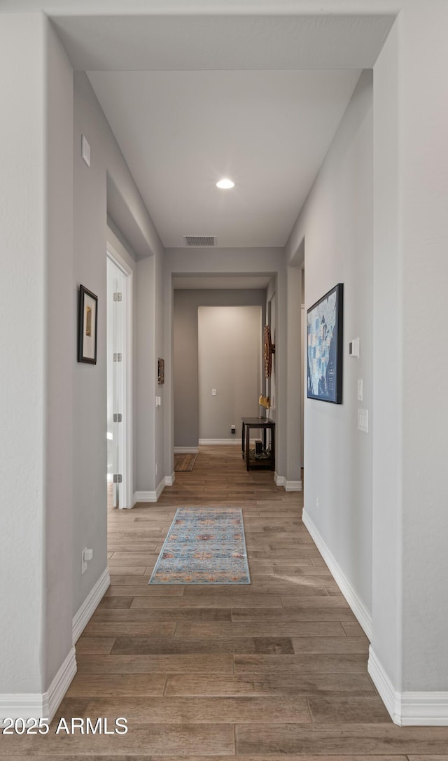 corridor with wood-type flooring