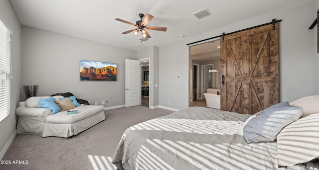 carpeted bedroom with a barn door and ceiling fan