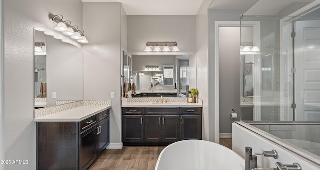 bathroom featuring a tub to relax in, hardwood / wood-style floors, and vanity