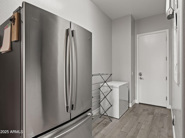 laundry room with light hardwood / wood-style flooring