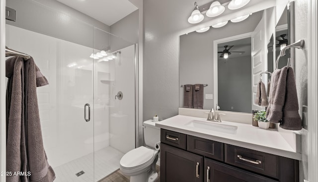 bathroom featuring vanity, toilet, and a shower with door