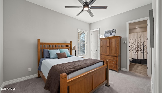 carpeted bedroom with connected bathroom and ceiling fan