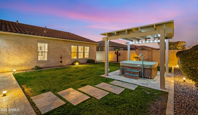 yard at dusk with a hot tub, a pergola, and a patio