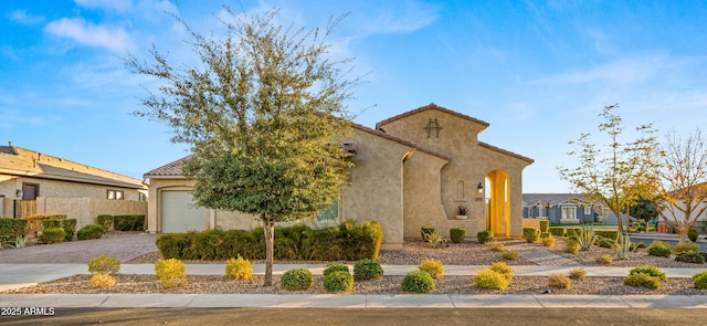 mediterranean / spanish home featuring a garage