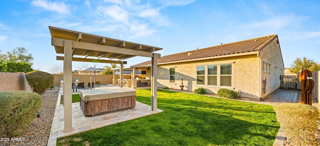 exterior space with a lawn, a hot tub, and a patio