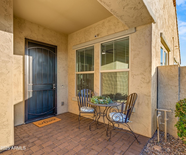 view of exterior entry with a patio