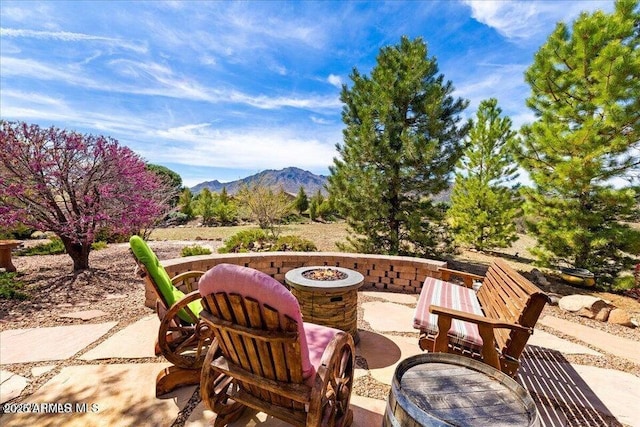 10796 N Saddle Pass Rd, Prescott, AZ 86305 - view of patio / terrace featuring an outdoor fire pit and a mountain view