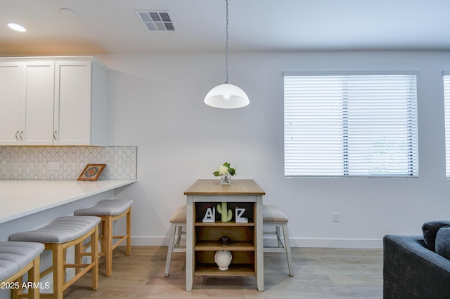 2511 W Queen Creek Rd Unit 374, Chandler, AZ 85248 - dining area featuring plenty of natural light, light wood-type flooring, and baseboards