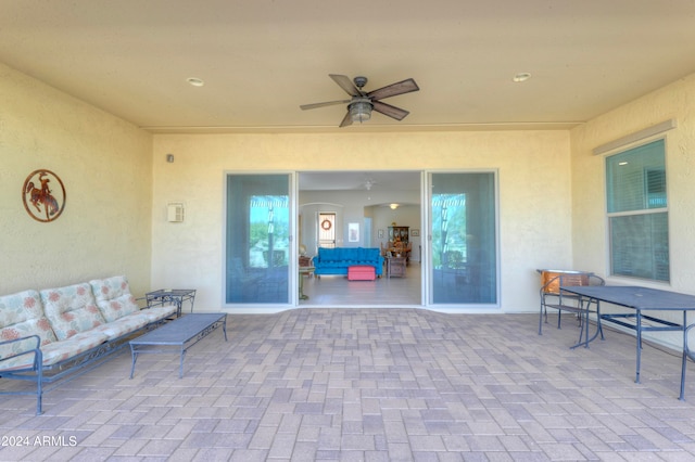 view of patio with an outdoor living space and ceiling fan