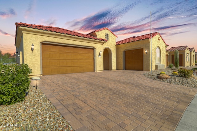 mediterranean / spanish home featuring a garage