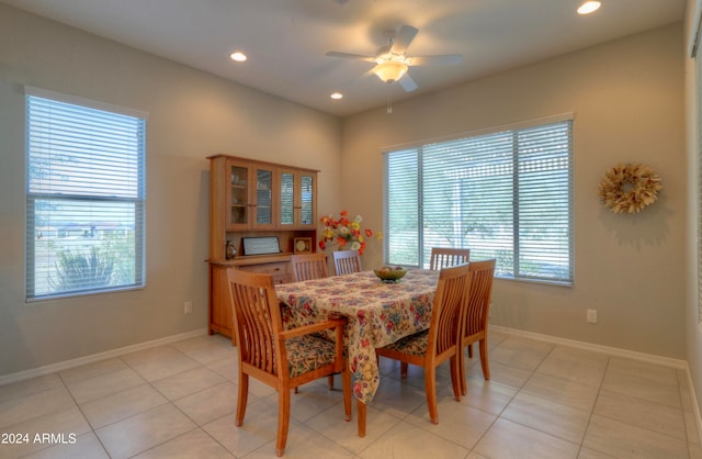 tiled dining space featuring ceiling fan