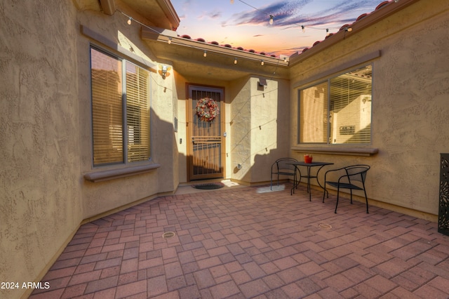 view of patio terrace at dusk