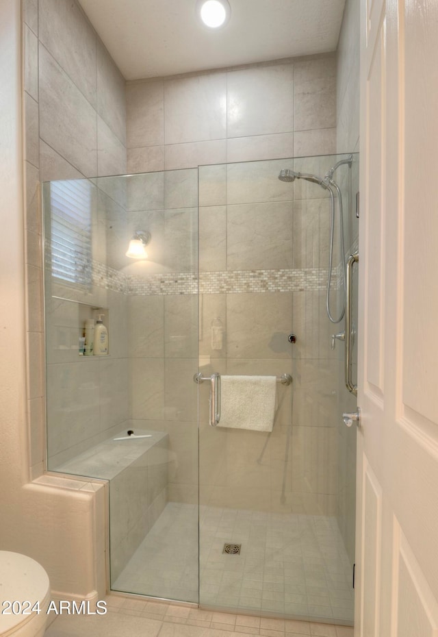 bathroom with walk in shower and toilet