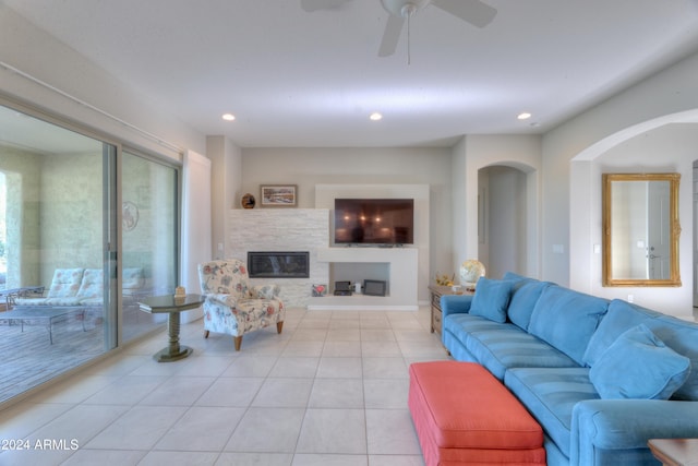 27552 W Tonopah Dr, Buckeye, AZ 85396 - living room with a glass covered fireplace, recessed lighting, light tile patterned flooring, arched walkways, and a ceiling fan