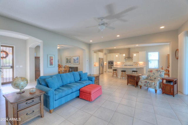 tiled living room with ceiling fan