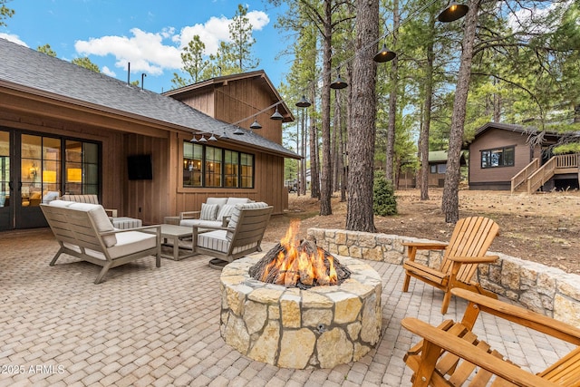 view of patio / terrace with an outdoor living space with a fire pit