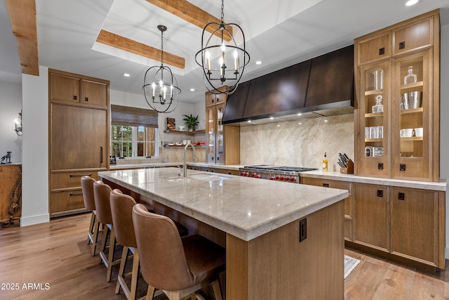 kitchen with recessed lighting, custom exhaust hood, and a sink