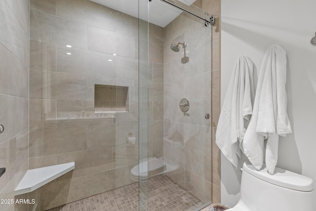 full bath with a stall shower and toilet