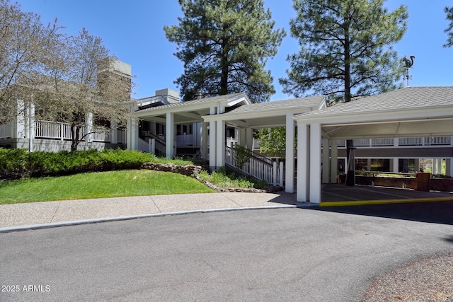 exterior space featuring covered parking and a chimney