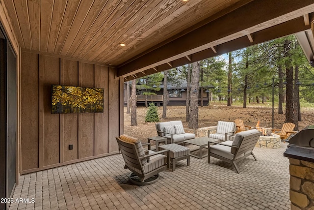 view of patio / terrace featuring an outdoor living space with a fire pit