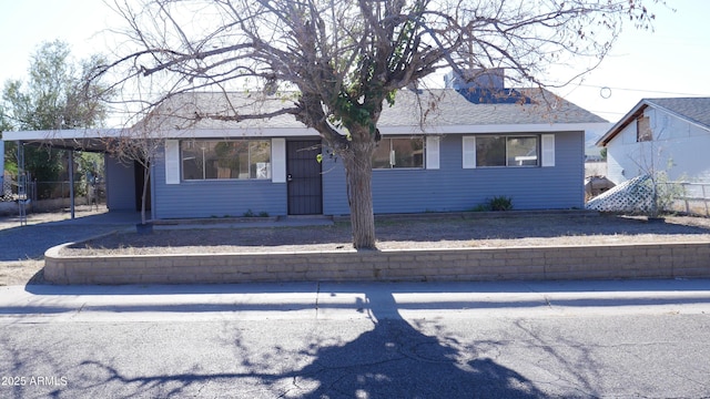 single story home featuring a carport