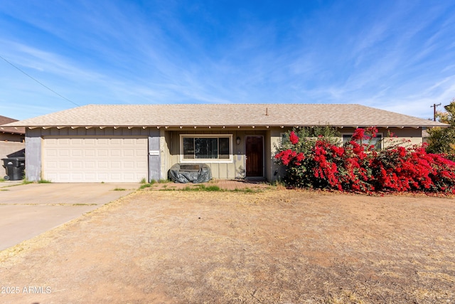 single story home featuring a garage, driveway, and a shingled roof