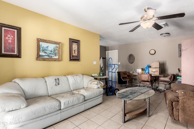 living area with light tile patterned floors, ceiling fan, and visible vents