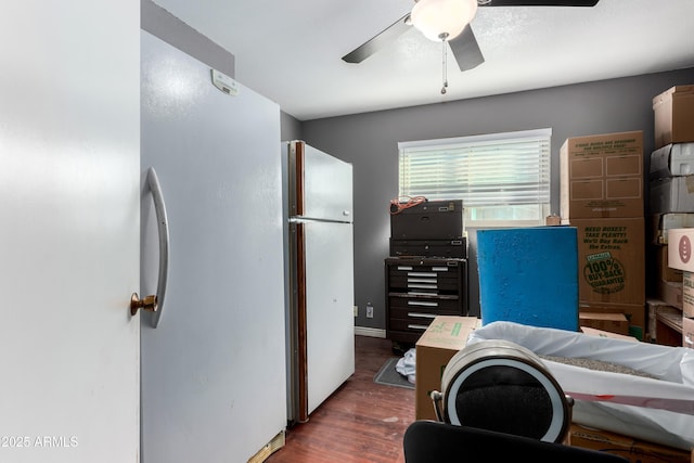 bedroom with ceiling fan, baseboards, wood finished floors, and freestanding refrigerator