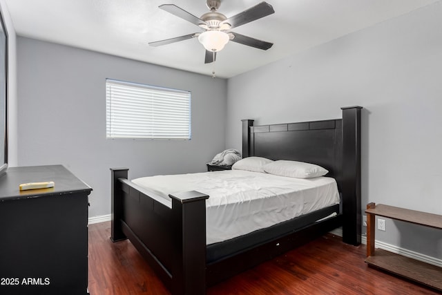 bedroom with wood finished floors, a ceiling fan, and baseboards