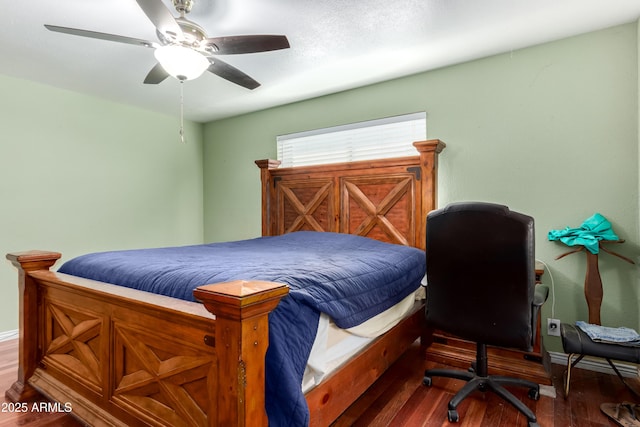 bedroom with a ceiling fan, baseboards, and wood finished floors