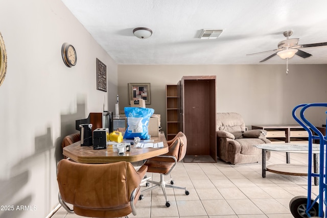 office space with a ceiling fan, visible vents, and light tile patterned flooring