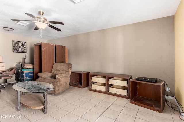 living area featuring light tile patterned flooring, visible vents, and a ceiling fan