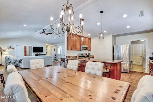 dining area with light wood finished floors, a ceiling fan, visible vents, lofted ceiling, and recessed lighting