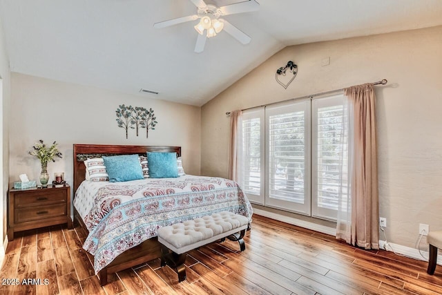 bedroom with lofted ceiling, visible vents, access to exterior, and wood finished floors