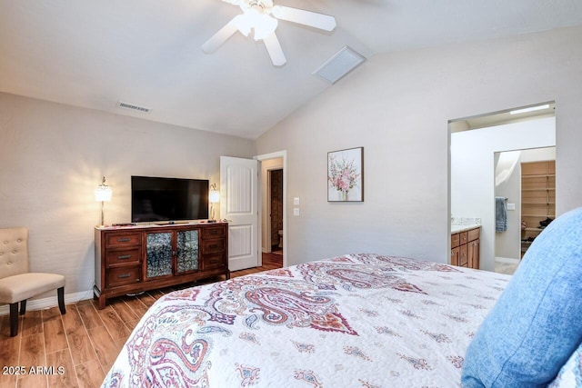 bedroom with baseboards, ceiling fan, visible vents, and wood finished floors