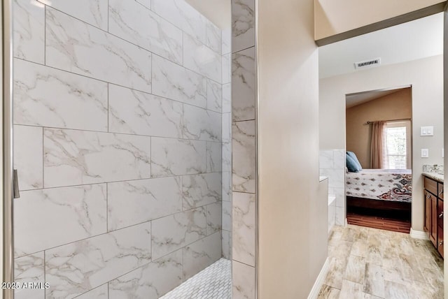 bathroom with walk in shower, ensuite bathroom, visible vents, and wood finished floors