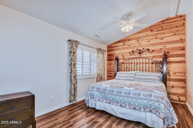 bedroom with vaulted ceiling, visible vents, and wood finished floors