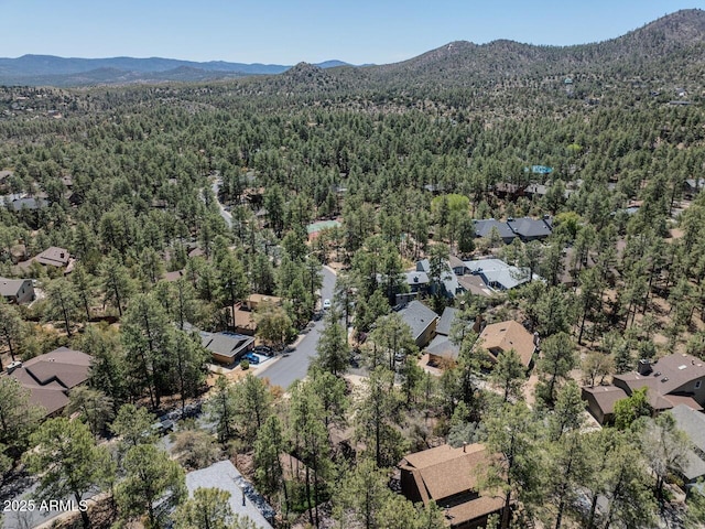 aerial view with a residential view, a mountain view, and a view of trees