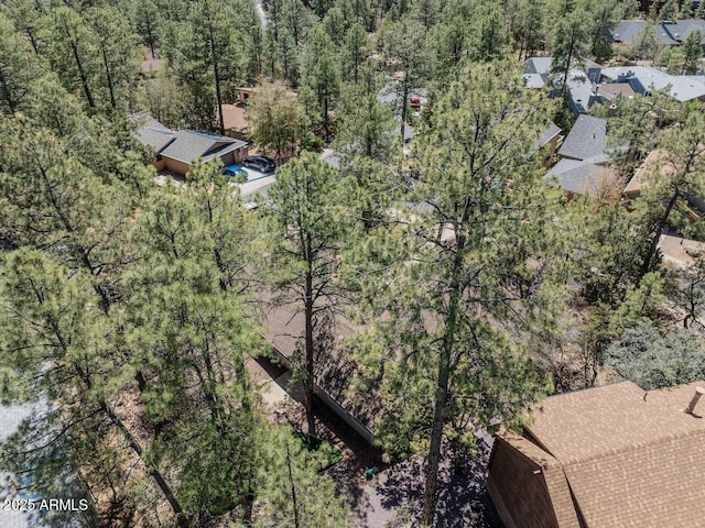 birds eye view of property with a forest view