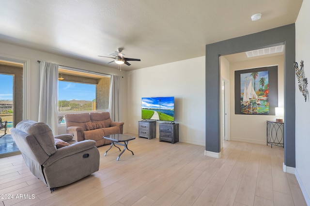 living room featuring ceiling fan and light wood-type flooring