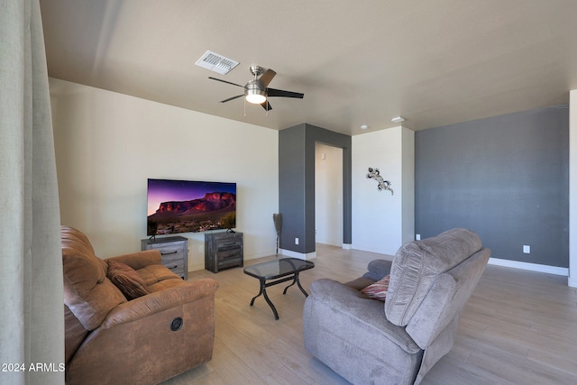 living room featuring light wood-type flooring and ceiling fan