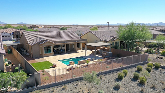 view of pool with a mountain view and a patio area