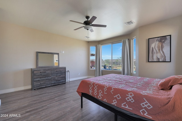 bedroom with dark hardwood / wood-style floors and ceiling fan