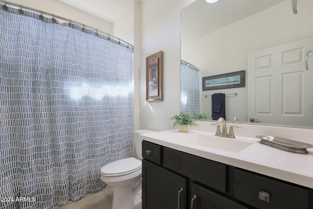 bathroom with vanity, walk in shower, toilet, and tile patterned flooring