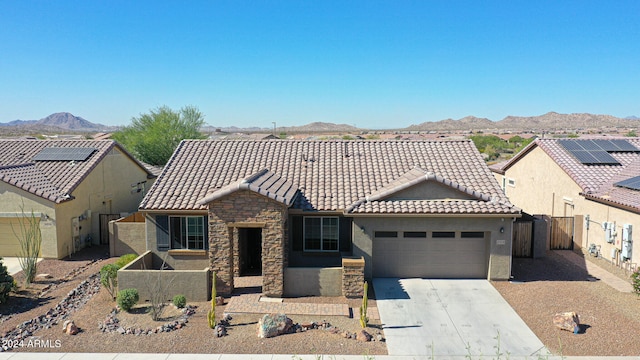 view of front of property with a garage and a mountain view