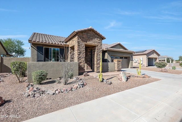 16918 S 180th Dr, Goodyear, AZ 85338 - ranch-style house featuring fence, an attached garage, a tile roof, stone siding, and a mountain view
