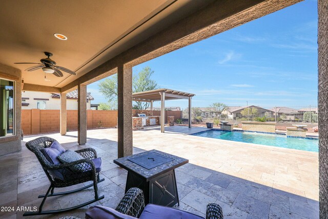 view of patio / terrace with a pergola, ceiling fan, pool water feature, and a fenced in pool