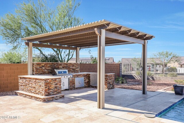 16918 S 180th Dr, Goodyear, AZ 85338 - view of patio featuring fence, a pergola, and exterior kitchen
